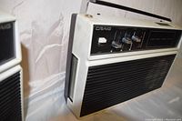 Side view of a vintage Craig 8-track portable radio showing the control panel with sliders and an extendable antenna.