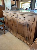 Front and side view showing three drawers and two cabinet doors