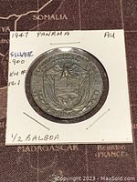 Obverse side of the 1947 Panama 1/2 Balboa silver coin showing the coat of arms and denomination.