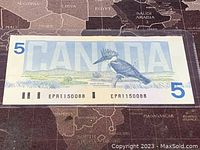 Front side of the 1986 Canadian 5 dollar banknote showing a kingfisher bird illustration and serial number EPR1150088