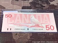 Reverse side of Canadian 50 dollar banknote with snowy owl design