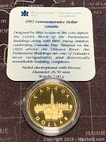 1992 Canadian commemorative dollar coin with descriptive card showing design and specifications