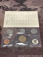 Original specifications card describing the coins with dimensions and metals