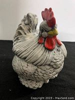 Front view of the ceramic rooster jar showing detailed feather texture and red comb.