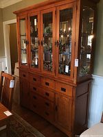 Full front view of two-piece china cabinet in room setting