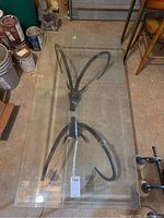 Overhead view showing entire glass top and both metal ram-head supports