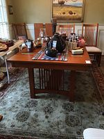 Full view of assembled table in room with chairs and tabletop items