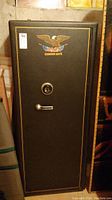 Front view of Cannon Safe floor safe showing closed door with lever handle, combination dial and lot sticker