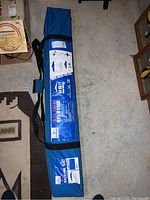 Blue carry bag containing Academy Sports Easy Shade 10x10 ft pop up tent with visible product labeling.