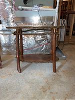 Full view of wood table showing tree limb legs and wood slab top with natural bark edges.