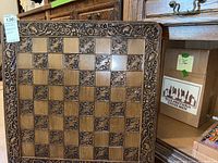 Full view of 24x24 carved wooden chess board with carved border and alternating relief squares