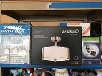 Photo showing boxes of lights including a 3 light bath bar, Artika ceiling light, and other lighting boxes stacked