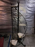 Front view of plant stand showing full spiral design and all five marble shelves.