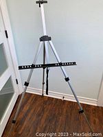 Photo of adjustable aluminum tripod artist easel with rubber feet showing full setup and details of the horizontal support bar.