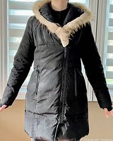 Front view of the black Atelier Noir women's medium jacket showing faux fur trim on hood, asymmetrical zipper, and front zippered pockets.