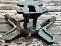 Close-up view of the base and central clamping mechanism of the heavy duty miter vise showing its cast metal construction and three arms with adjustment screws