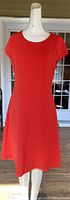 Front view of the orange Jones New York dress on mannequin, showing short sleeves, round neckline and flared skirt.