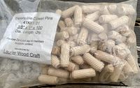 Bag labeled 'Expansible Dowel Pins 41K-1.01 3/8" Dia Length Qty 100' containing about 100 light wood colored dowel pins with ridges.