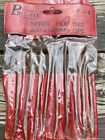 Riffler file set in original packaging showing 9 pieces tightly packed in red holder inside clear plastic.