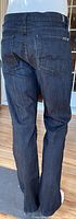 Back view of the dark blue denim jeans showing pockets and stitching details.