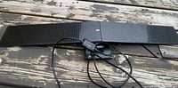Full view of black rectangular flush mount indoor TV antenna with attached USB amplifier and cable