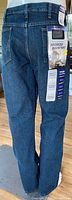 Back view of Wrangler men's jeans showing tags and pocket details.