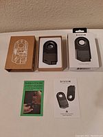 Photo showing the contents of the lot: the lighter in a foam insert box, external packaging, instruction brochures.