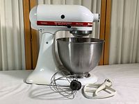 Overview photo of KitchenAid Ultra Power KSM90 mixer with stainless steel bowl, wire whisk attachment, and flat beater mixer blade.