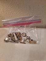 Plastic bag containing assorted costume jewelry pieces
