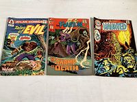 Front cover view of three vintage comics: Atlas Tales of Evil No. 1 (1975), Charlotte The Phantom No. 58 (1973), Charlotte Haunted No. 20 (1975). Shows good condition with minor edge wear.