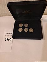5 vintage nickels displayed in black velvet presentation box