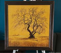 Full view of the vintage Tree of Life artwork featuring a large tree in a field with no leaves, framed and positioned on a stand.