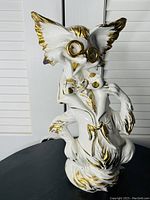 Front view of the tall ceramic cat figure with large ears, gold trim accents, glasses, and bow tie, standing pose.