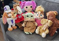 Wide view of the seven plush dolls showing all character details and colors
