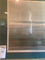 Close view of print showing abstract horizontal bands of green, beige and teal under glass with green mat border