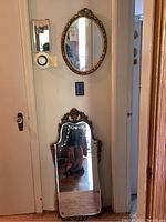 Both mirrors displayed vertically on wall and floor, showing overall size and frame styles.