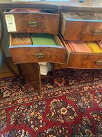 Image showing two open wooden drawers with assorted table dressings inside including napkins and placemats