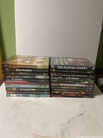 Photo of stacked DVDs showing 10 titles including Redemption: The Robbie the Dead, Island, The Forsaken, The Matador, Don Juan DeMarco, Justin Timberlake Justified, Beyoncé B'Day, Traffic, Close Encounters, and The Beach.