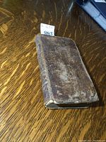 Front cover view of leather binding showing scuffs and overall wear
