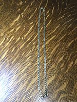Full length chain laid flat on wooden surface