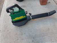 Side view of the green Weed Eater gas powered leaf blower vac showing model 1966 and branding.