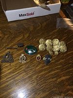 View showing all badges and buttons from the collection including brass buttons and various uniform badges.