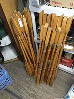 Multiple solid oak spindles bundled together, showing natural wood finish and doweled bottoms.