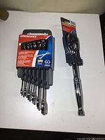Full view of the Crescent 6 piece combination wrench set in its packaging alongside the 1/2 inch drive ratchet still in plastic holder.