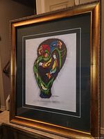 Framed acrylic painting showing full artwork, matting, and gold frame from an angle.