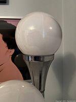 Close-up of top white opaline glass globe and chrome holder