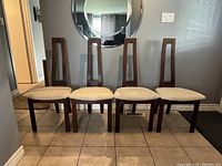 Four chairs lined up front view in interior setting