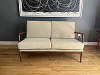 Front view of loveseat showing full frame and cushions