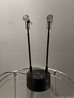 Dual spotlight heads and cylindrical base front view