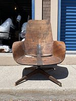 Front view of molded plywood shell mounted on base